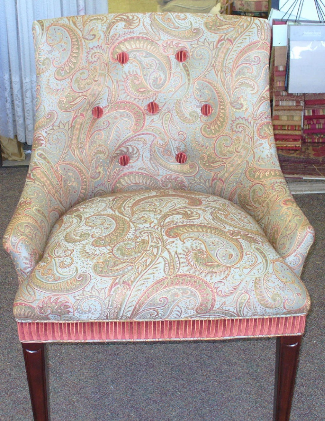 Paisley upholstered chair with contrasting striped trim