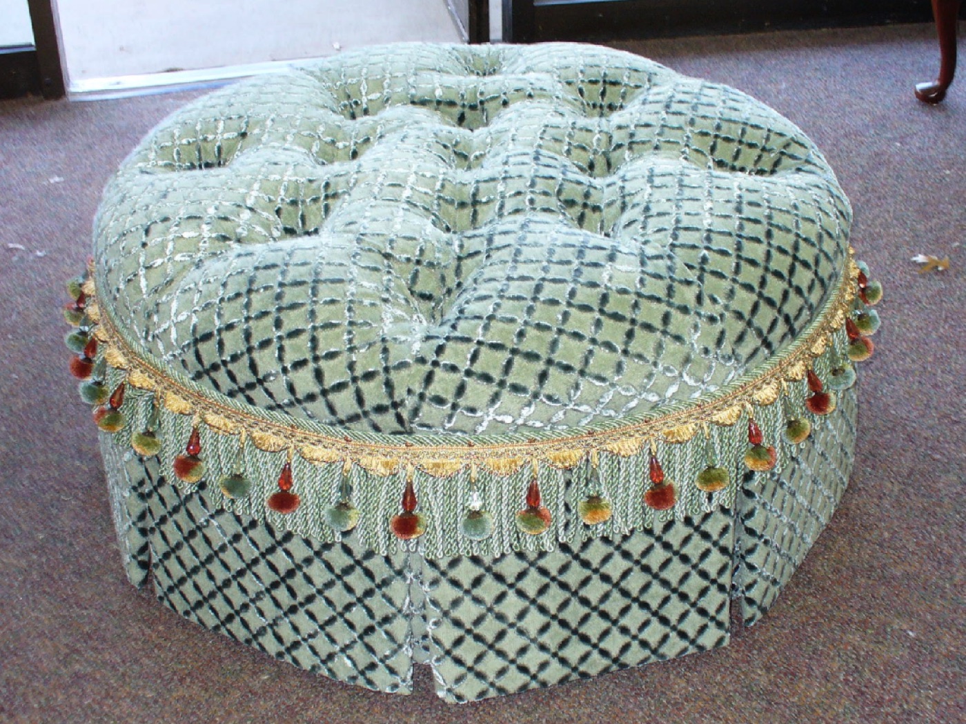 Tufted patterned ottoman with tassel trim